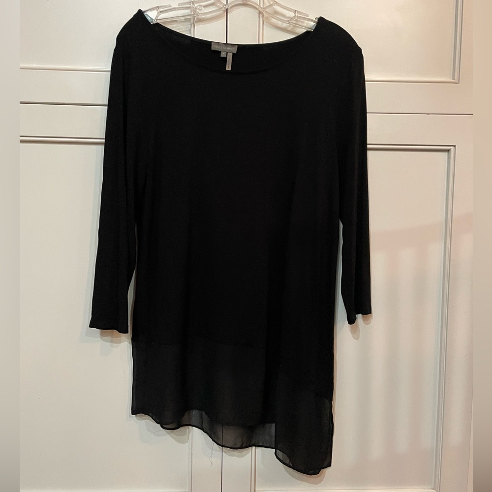 Small black Vince Camuto asymmetrical top with sheer material at bottom.